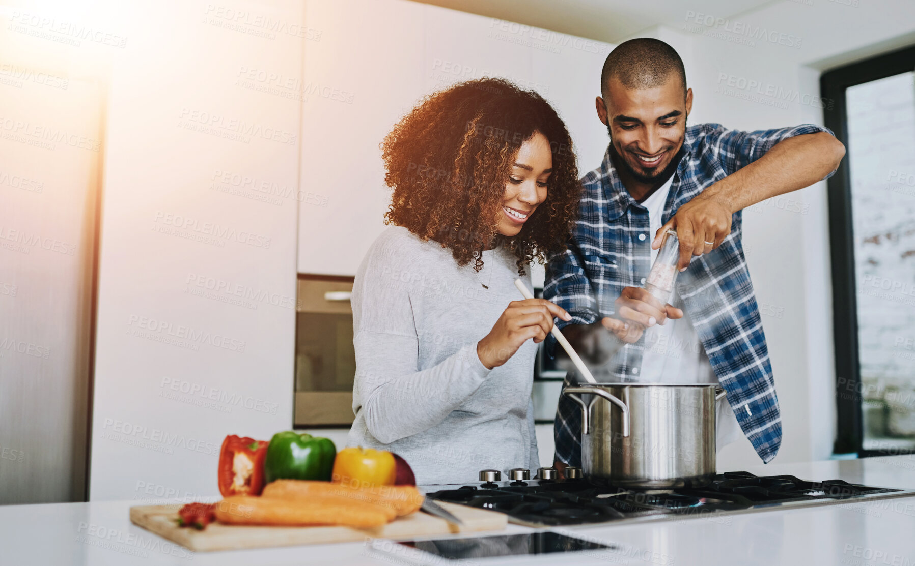 Buy stock photo Happy couple, cooking and romance in kitchen for lunch, trust and love in relationship. Man, woman and marriage at home for support, preparing meal and recipe with vegetables for anniversary dinner