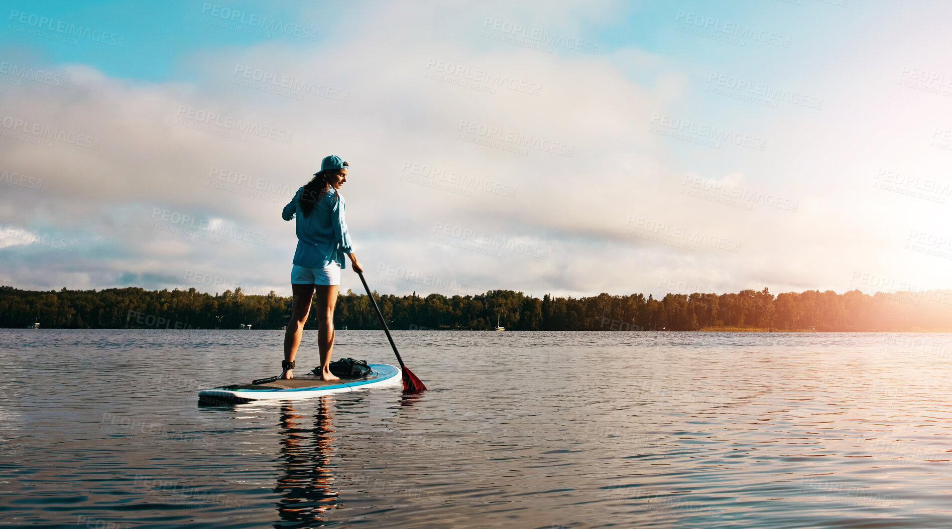 Buy stock photo Standing woman, back and paddle board in river for calm exercise with summer vacation, training and sports in water. Girl, balance and floating in lake for wellness, holiday sunset and cardio workout