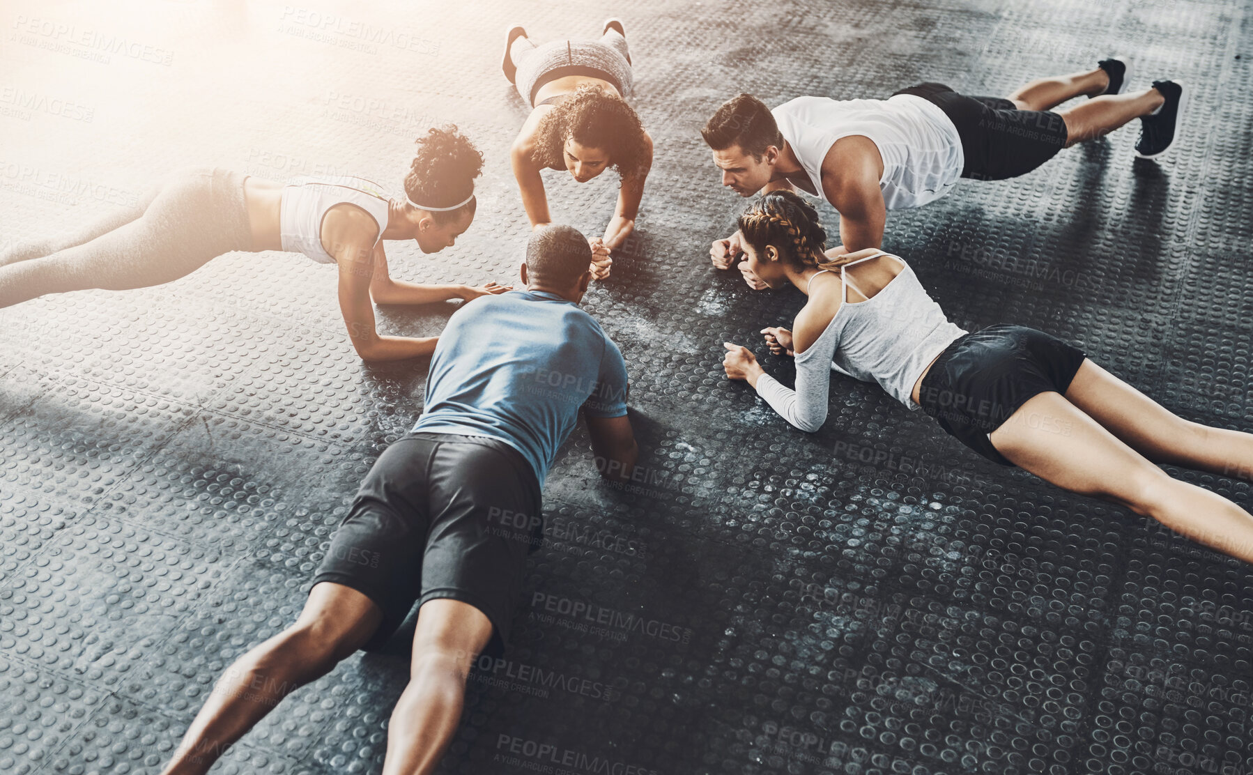 Buy stock photo People, fitness and plank in group at gym for workout, core exercise or training together indoors. Diverse class, friends and warm up for ab muscle, session and sport for health above gymnasium floor