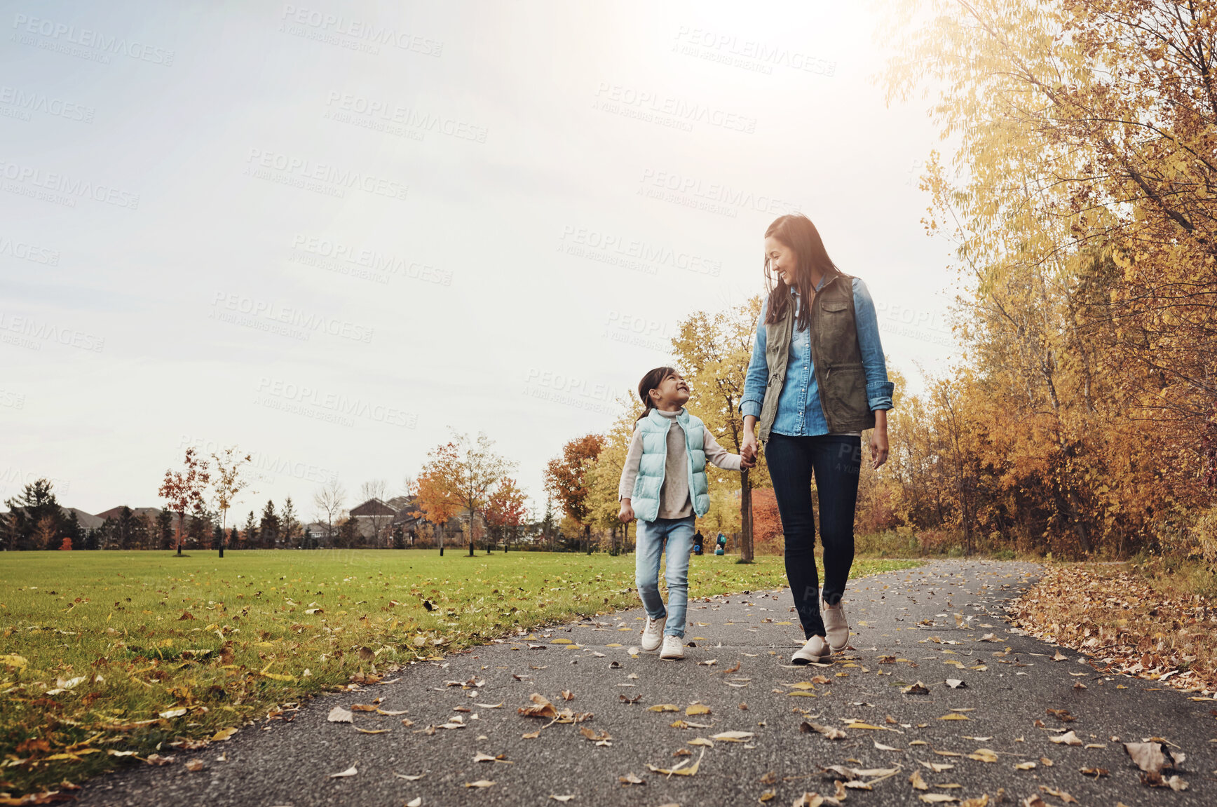 Buy stock photo Walking, park and mother holding hands with child for adventure, wellness and fresh air outdoors. Family, weekend and happy mom with young girl on path for bonding, fun and relax together in nature