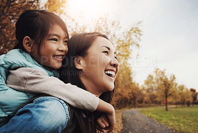 Buy stock photo Happy mother, daughter and piggyback with child in nature for bonding, holiday or outdoor weekend. Asian mom carrying kid or little girl with smile for hug, embrace or childhood in autumn season