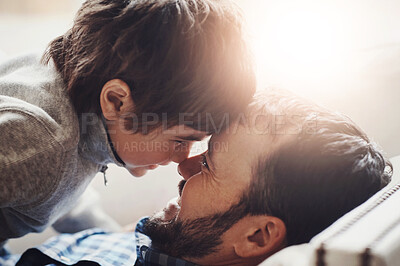 Buy stock photo Morning, happy and father with son on sofa for bonding, loving relationship and forehead touch in home. Family, lens flare and dad with boy embrace with faces together, hug and smile in living room