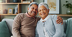 Portrait, senior couple and hug on sofa in living room for support, relax and retirement. Embrace, man and woman happy in apartment with hug, smile and loyalty by elderly people, commitment and love