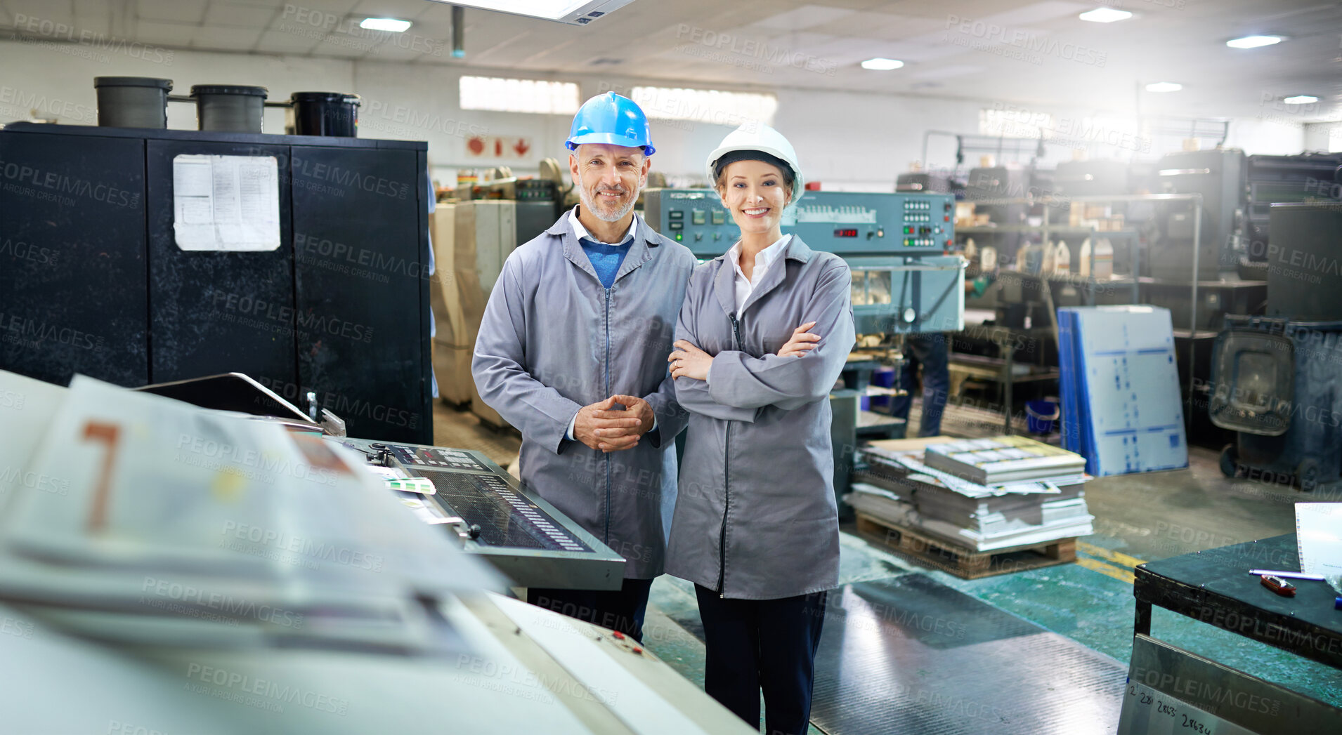 Buy stock photo Man, woman and arms crossed in portrait at factory for printing by machine, maintenance and production at job. People, smile and helmet in industrial warehouse for design, brochure or team for paper