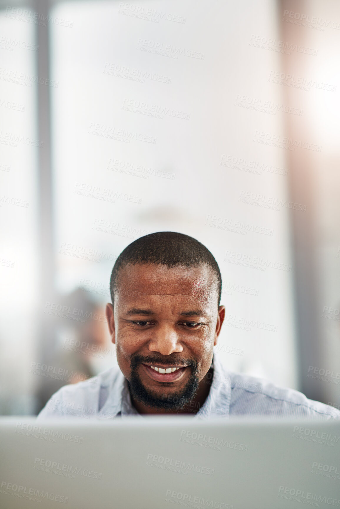 Buy stock photo African man, computer and space in office for mock up, reading and thinking at media company. Black business person, mature editor and writer by pc, review and smile for story at creative agency