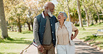 Senior couple, hug and laughing in park for wellness, health and bonding in spring and walking. Excited interracial and elderly people with support, care and talking of walk or health journey outdoor