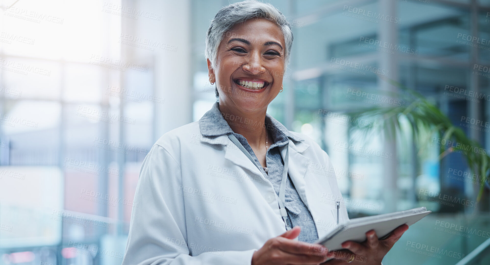 Buy stock photo Female doctor, portrait and smile with tablet in hospital or workplace with lens flare. Communication, technology and medical research for innovation in medicine with happy healthcare professional.