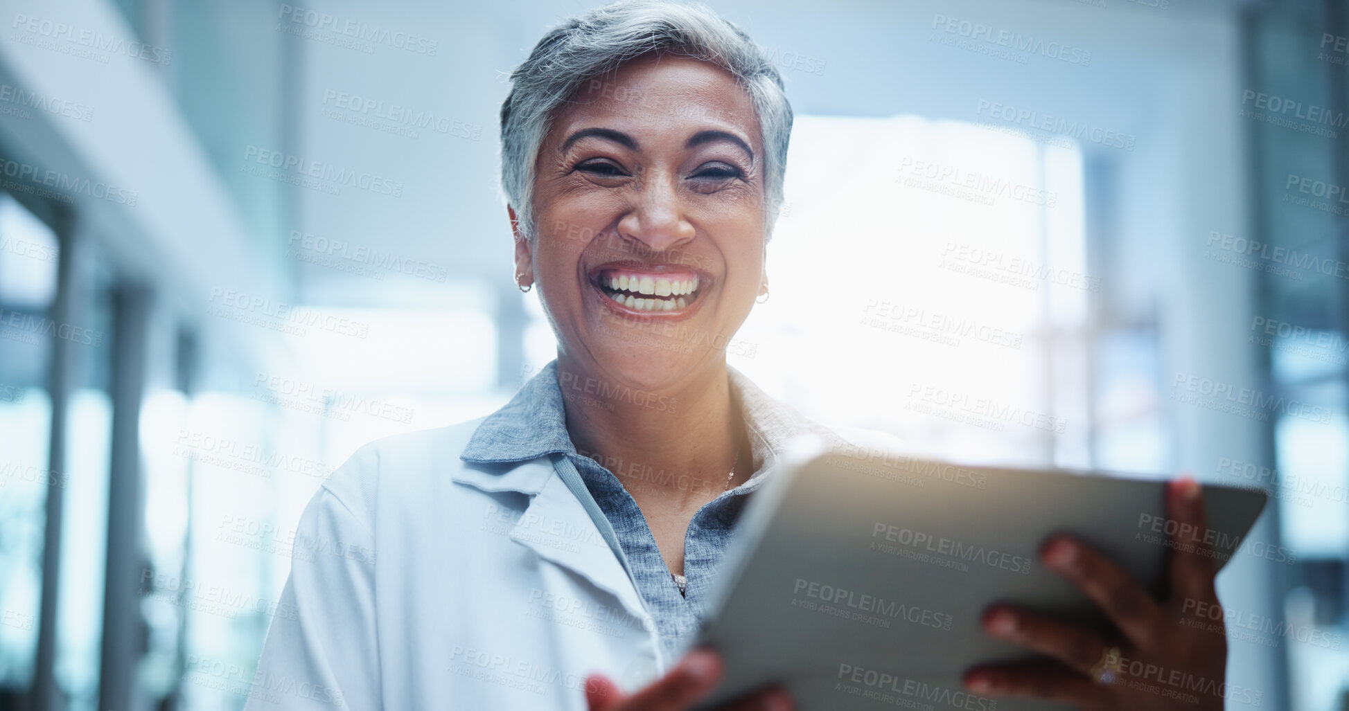 Buy stock photo Female doctor, smile and portrait with tablet in hospital or workplace with lens flare. Technology, communication and medical research with person in medicine with happy healthcare professional