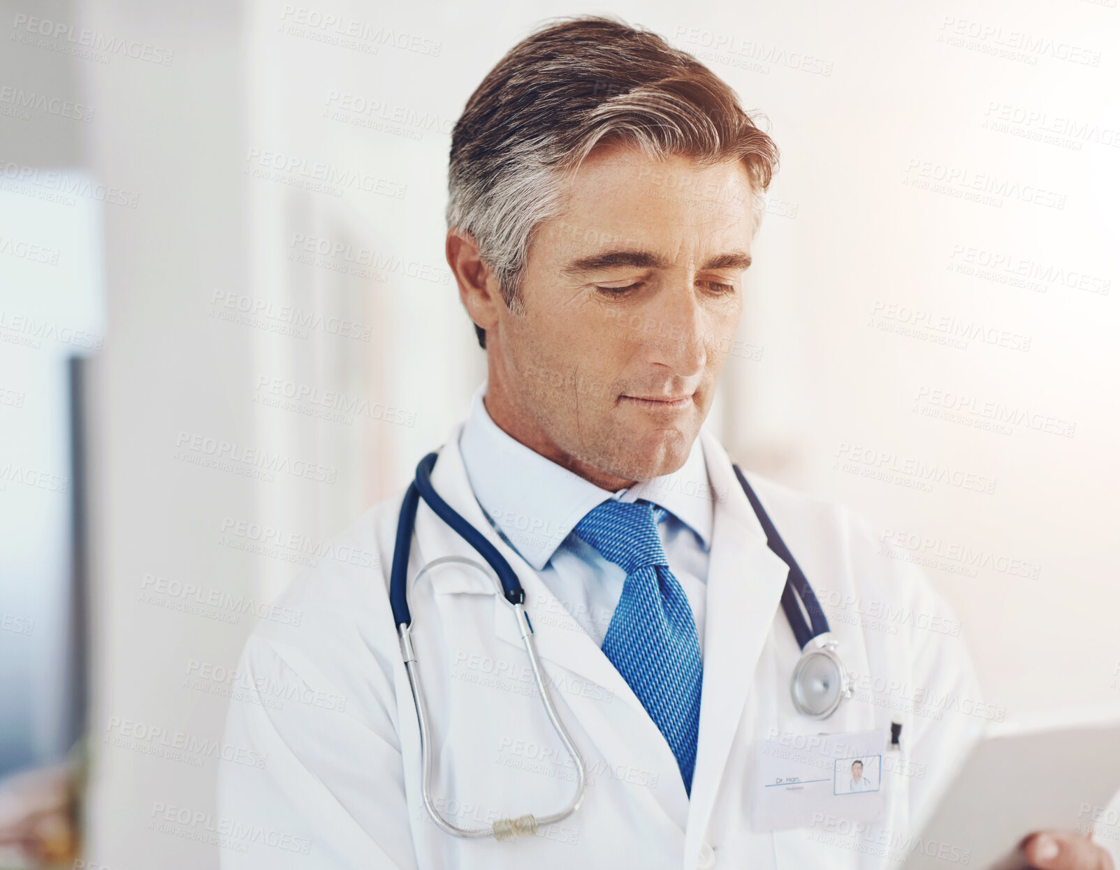 Buy stock photo Doctor, man and research on tablet for healthcare, information or telehealth in hospital. Digital technology, medical professional and reading email on internet for wellness report or clinic results