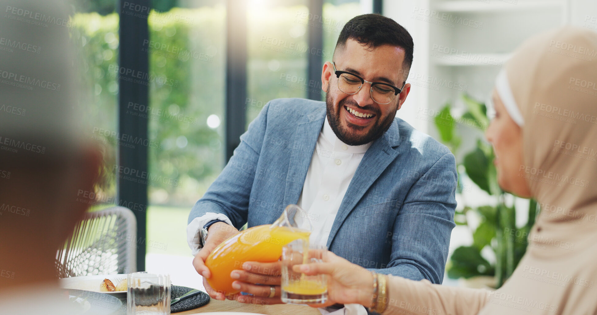 Buy stock photo Smile, juice and muslim family in home for breakfast, bonding and healthy dish together. Happy, love and islamic man pour nutrition fruit drink for wife at morning meal in dining room at house.