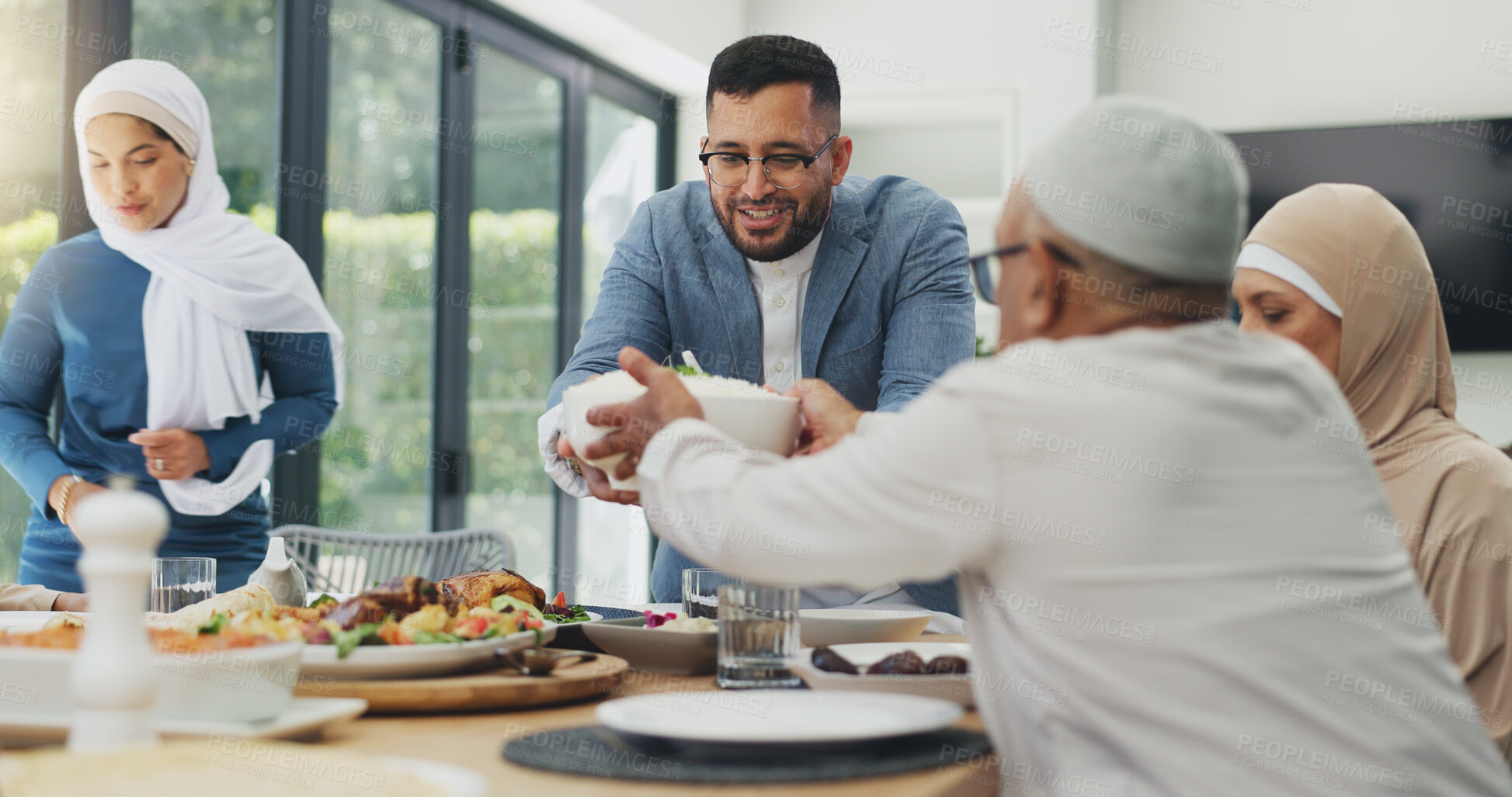 Buy stock photo Muslim family, social gathering and food for celebration of Eid, healthy meal and conversation in house. Islamic people, grandparents and mother with father, lunch and happiness with salad and relax