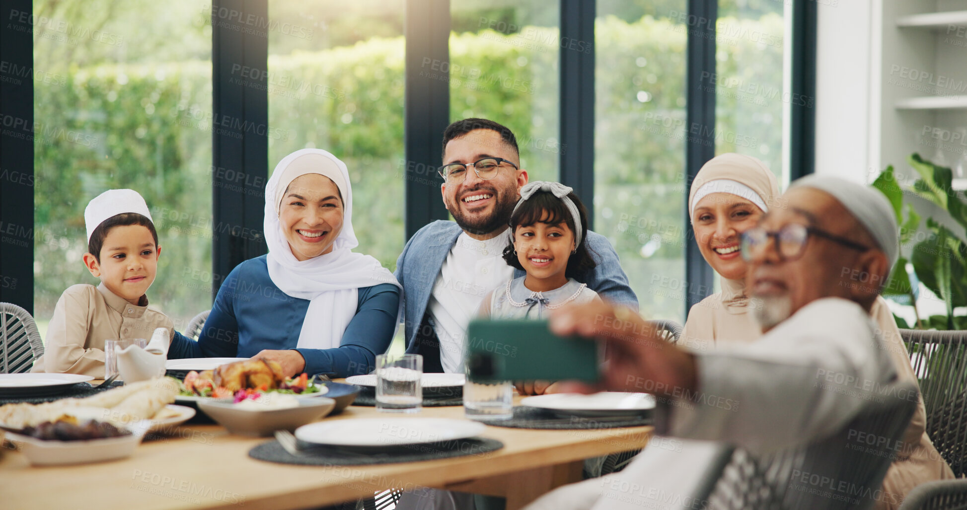 Buy stock photo Muslim, family and eating food with selfie for eid mubarak in living room of house for celebration. Islamic, memory and festival with dinner in lounge of home for culture or tradition after ramadan