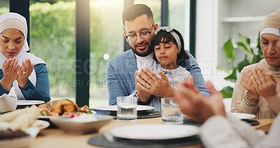 Buy stock photo Muslim, prayer and eating food with family for eid mubarak in living room of house for celebration. Islam, gratitude and festival with dinner in lounge of home for culture or tradition after ramadan