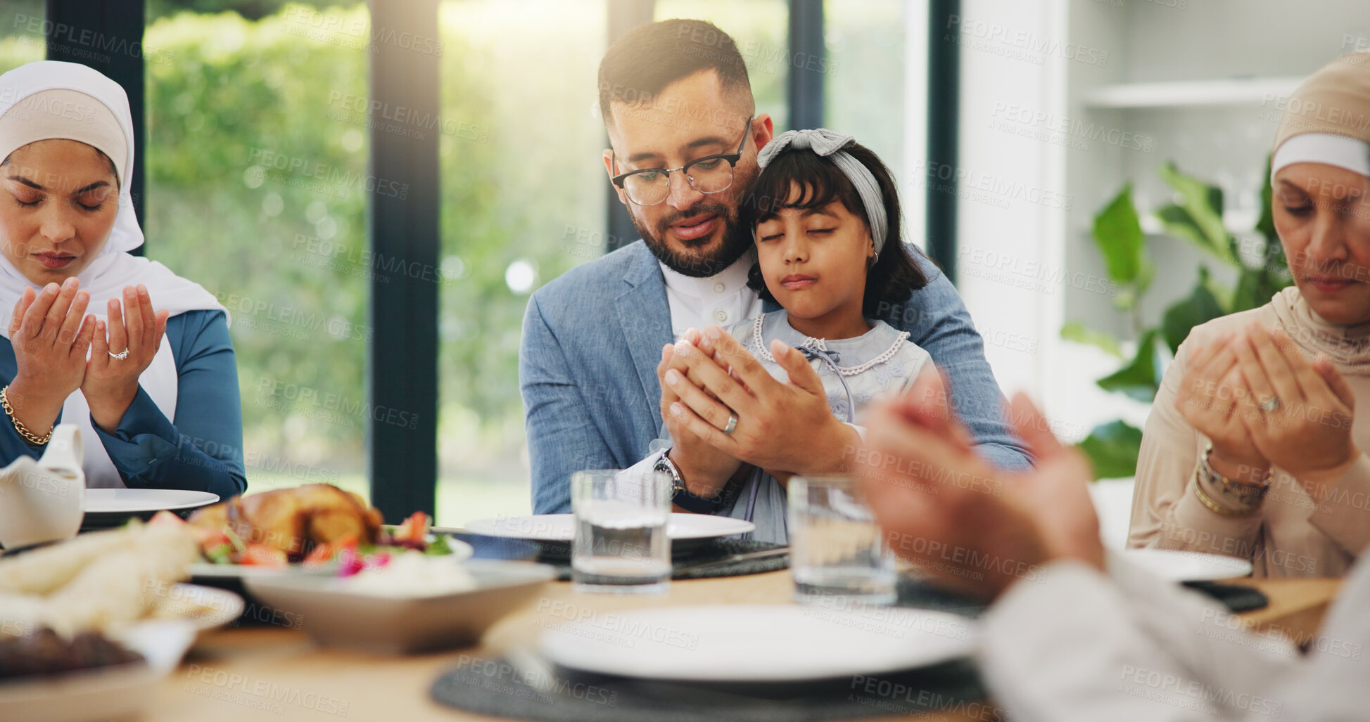 Buy stock photo Muslim, prayer and eating food with family for eid mubarak in living room of house for celebration. Islam, gratitude and festival with dinner in lounge of home for culture or tradition after ramadan