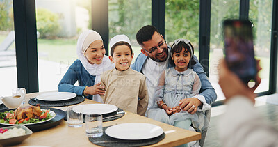 Buy stock photo Muslim, phone and photography with family lunch for eid mubarak in living room of house and celebration. Islam, mobile and memory with dinner in lounge of home for culture or festival after ramadan