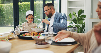 Buy stock photo Father, son and dinner at dining table for ramadan, muslim celebration and eating food at home. Eid mubarak, culture and religious gathering with islamic family, son and dad with salad for serving