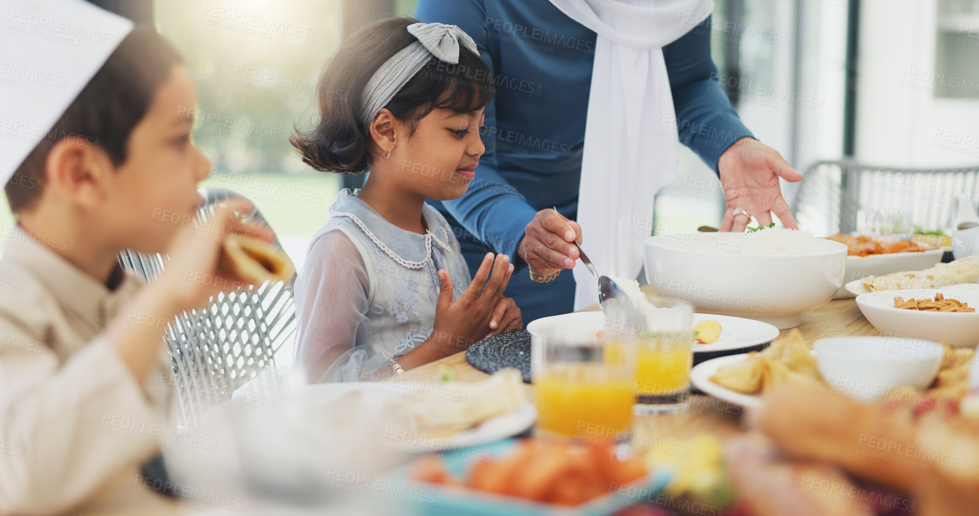 Buy stock photo Muslim, children and eating food with family for eid mubarak in living room of house for celebration. Islamic, kids and festival with dinner in lounge of home for culture or tradition after ramadan