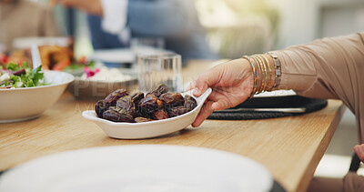 Buy stock photo Dates, fruit and hand with bowl on table for dinner or celebration in house with healthy organic choice. Heart health, low blood sugar and cholesterol benefits with vitamins, raw and delicious.