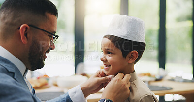 Buy stock photo Muslim, dad and dressing of child in home, celebration and holiday of Eid al Fitr, religion and clothes for culture. House, man and son in dining room, ready and happy for Ramadan, festive and feast