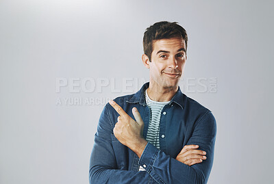 Buy stock photo Portrait, pointing and man with review, opportunity and model on grey studio background. Face, person and guy with hand gesture, mockup space and promotion with discount deal, information and review