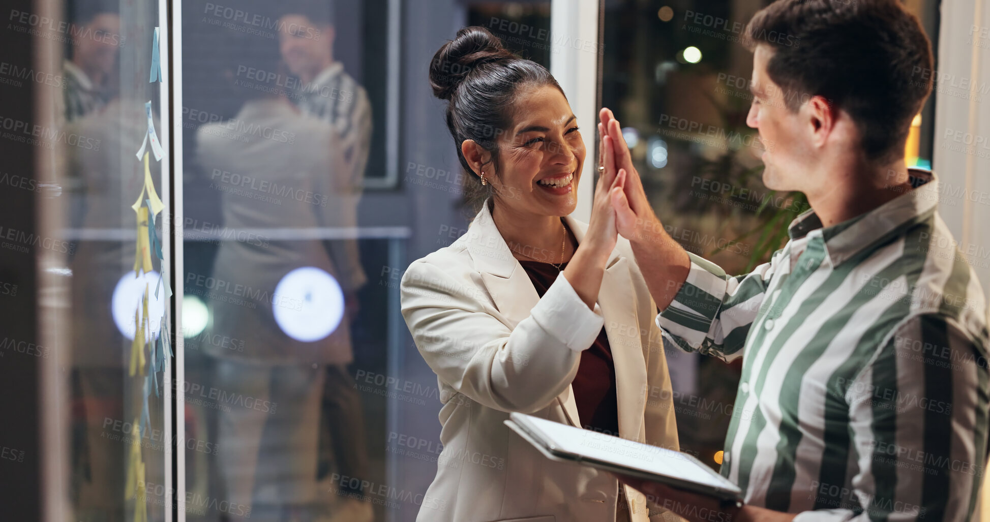 Buy stock photo Night, tablet and business people with high five, success and agreement with cooperation, partnership and teamwork. Evening, staff and employees in office, hand gesture and tech for support and app