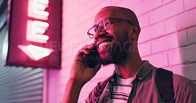 Buy stock photo Happy man, laughing and conversation with phone at night for communication outside bar, pub or neon light. Male person talking with smile in happiness on mobile smartphone for friendly discussion