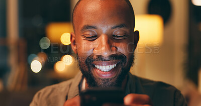 Buy stock photo Phone, night and black man on social media to relax reading online research or entertainment on blog website. Smile, face or happy African person on mobile app for news or funny internet meme in home