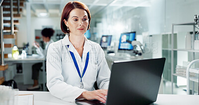 Buy stock photo Scientist, woman and typing on laptop in lab, medical professional and bioinformatics analysis online or research study. Innovation, information and working, recording experiment and data development