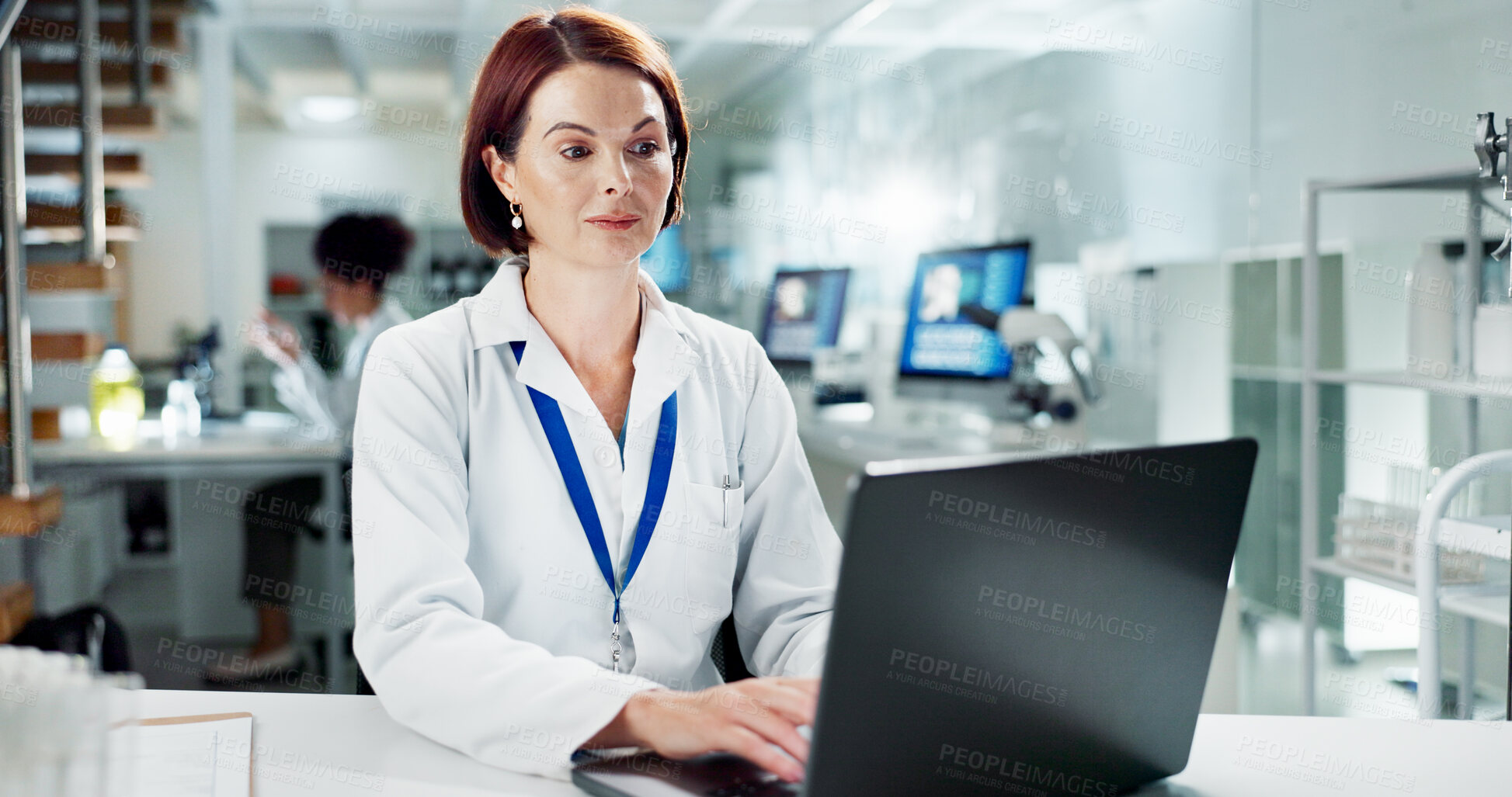 Buy stock photo Scientist, woman and typing on laptop in lab, medical professional and bioinformatics analysis online or research study. Innovation, information and working, recording experiment and data development