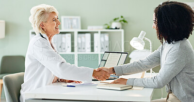 Buy stock photo Mature woman, doctor and handshake with patient for consultation, agreement or checkup at hospital. Female person or medical professional shaking hands with client for meeting, deal or appointment