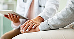 Doctor, patient and holding hands with tablet in consultation with support, empathy and announcement. Medic, person and touchscreen with comfort, diagnosis or app with healthcare service at hospital
