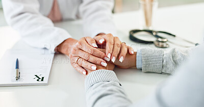 Buy stock photo Doctor, patient and holding hands on desk in consultation room with support, empathy and announcement. Medic, person and care with comfort, diagnosis and helping with healthcare service at hospital