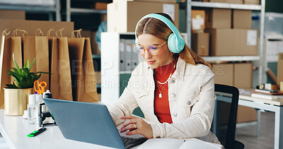 Buy stock photo Woman, laptop and small business with headphones, reading and logistics for thinking, sales report and ecommerce. Startup, computer and planning schedule for delivery, courier or supply chain on web