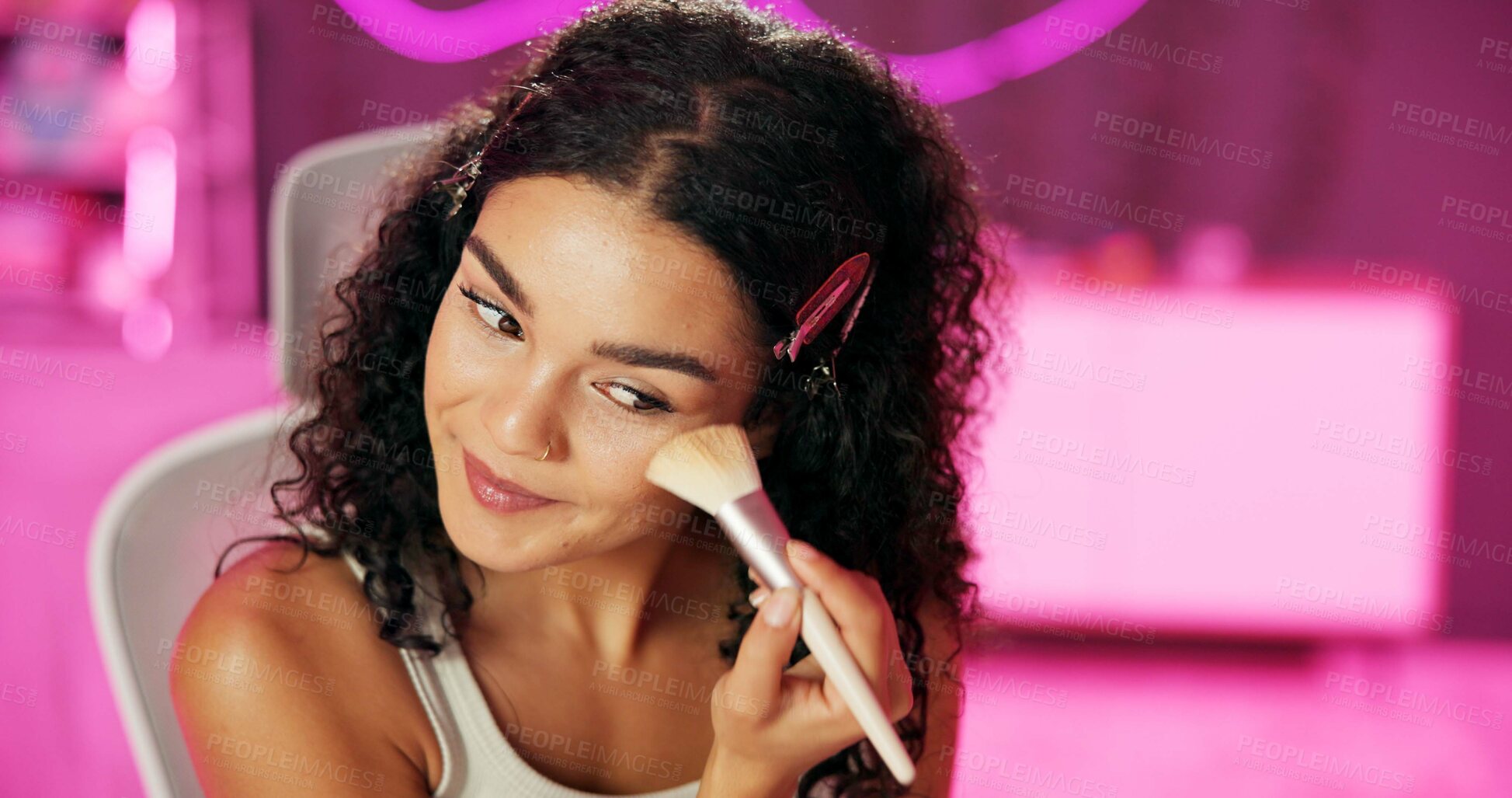 Buy stock photo Bedroom, girl and smile with application of makeup for cosmetics, beauty and morning routine. Neon, female person and facial product for getting ready with foundation, brush and technique at home