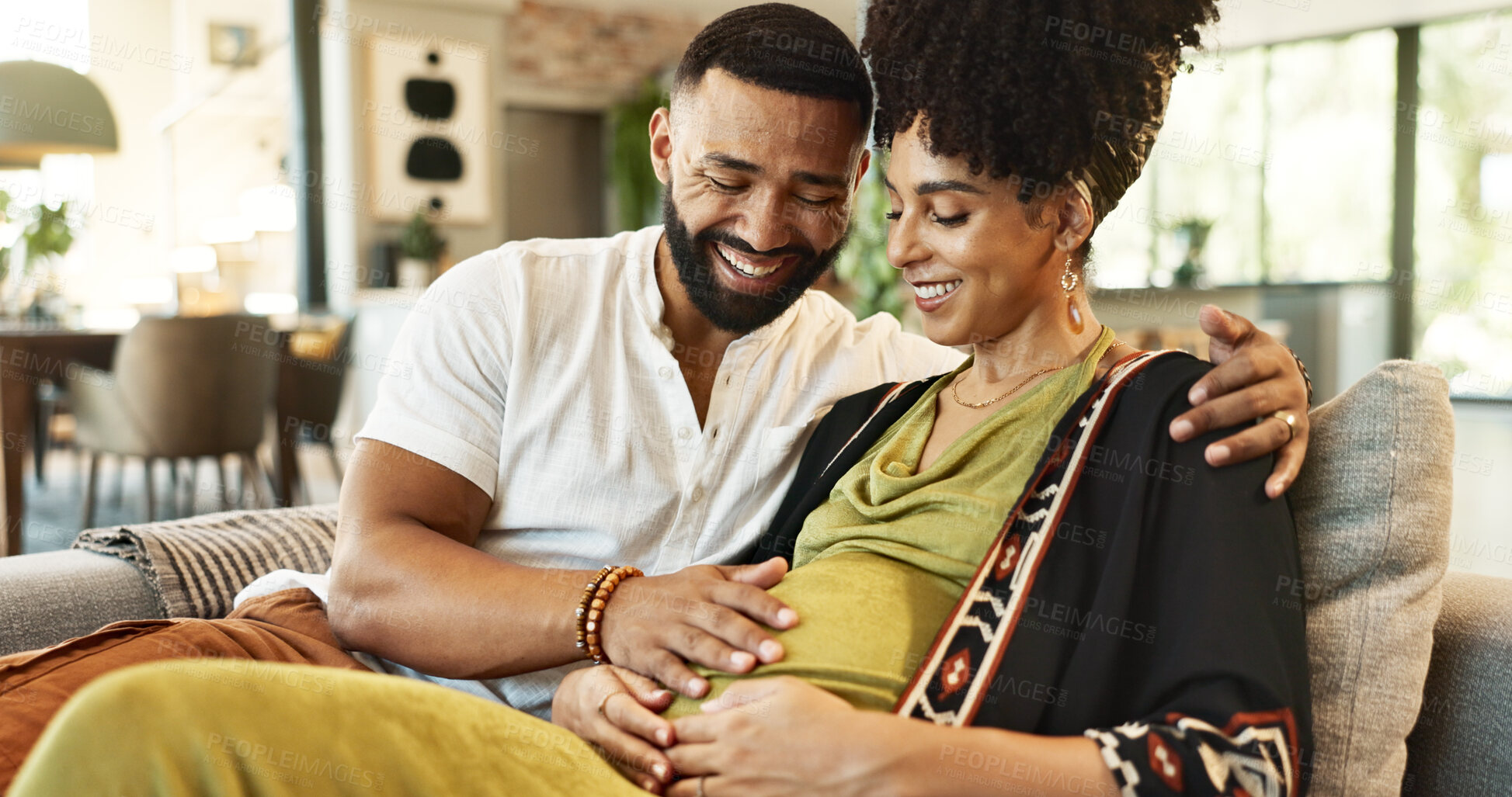 Buy stock photo Pregnant, couple and woman on sofa with bonding, tummy touch and support with maternity and motherhood. Future parents and affection on couch with healthy pregnancy, embrace and excited for baby