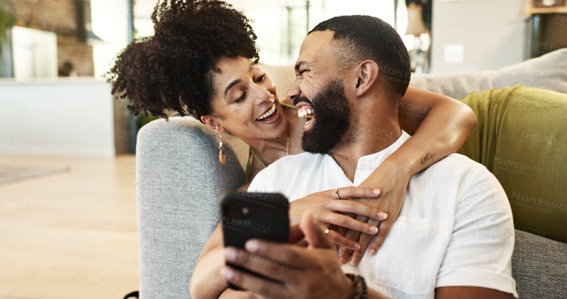 Buy stock photo Couple, hug and laughing for phone in home with social media meme, internet joke and comic notification. People, happy and smartphone in living room with funny web search, bonding or embrace in house