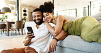 Couple, phone scroll and couch with social media, streaming and hug together in home with app. Online shopping, relax and happy people with technology and mobile video with web meme on the internet