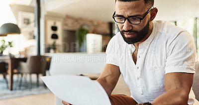 Buy stock photo Man, documents and finance with budget in home for mortgage loan, investment planning or bills. Person, research and glasses with banking paperwork on sofa with invoice for expenses, savings or taxes