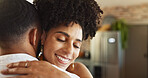 Couple, love and happy in home with hug for romance, bonding and commitment in marriage in kitchen. People, woman and smile with embrace in house for support, trust and healthy relationship with care