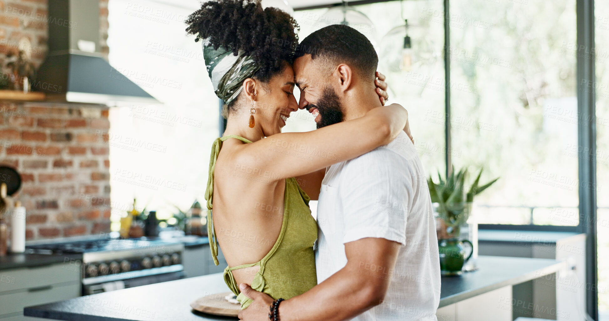 Buy stock photo Love, hug and couple in a kitchen with care, trust and bonding in their home together. Happy, support and people embrace in house with romance, commitment and security, safety and soulmate connection