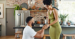 Couple, proposal and happy with engagement in home for commitment, marriage promise and ring box on knee. People, question and romantic gesture in kitchen of house with love, future together and yes