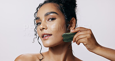 Buy stock photo Skincare, portrait and woman with gua sha jade for wellness, dermatology and luxury spa. Body, cosmetics and lady glow with stone crystal, anti aging or natural treatment on white studio background