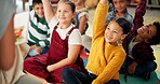 Children, teacher and hands up in classroom for reading question or back to school, learning or education. Kids, group and friends on floor for storytelling knowledge or library, growth or studying