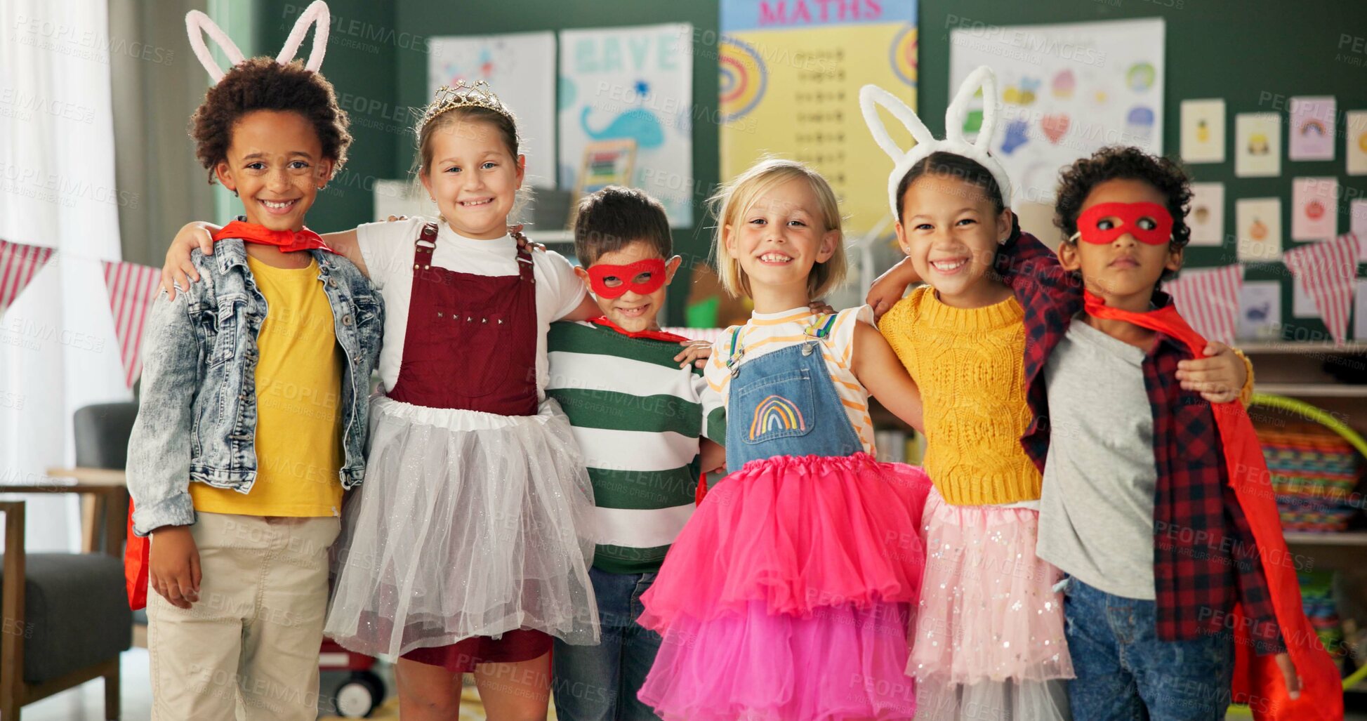 Buy stock photo Happy kids, friends and hug with costume in class for dress up or casual day at school together. Portrait of young group with smile for halloween in cosplay outfit, hero or fairy tale in classroom