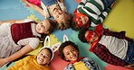 Happy children, friends and costume in class above on floor for dress up or casual day at school. Top view, portrait or young kids with cosplay outfit, hero or fairy tale in halloween classroom