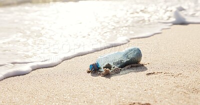 Buy stock photo Beach, ocean and plastic bottle in sand for pollution, litter and trash in sea for global warming crisis. Nature, climate change and closeup of garbage in sea to reduce waste, recycling and cleaning