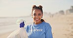 Woman, volunteer and face on beach with plastic bag for cleaning garbage, community service or sustainability. Female person, smile and trash recycling for climate change, planet or waste management