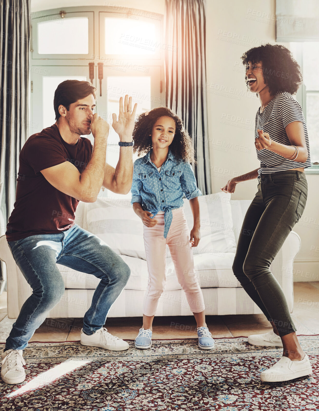 Buy stock photo Dancing, family and child with love, support and care for trust, together or happiness in bonding. Parents, woman and kid with man in playful, connection and comfort on couch in home or living room