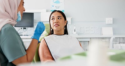 Buy stock photo Woman, dentist and consulting with patient for dental care, teeth cleaning or treatment at the clinic. Face of young female person or orthodontist consulting customer for oral, gum or tooth whitening