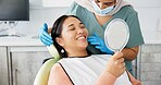 Dentist, woman patient and mirror for dental care results, teeth and smile at consultation. Medical, healthcare and orthodontist in clinic, oral hygiene examination and happy female person at checkup